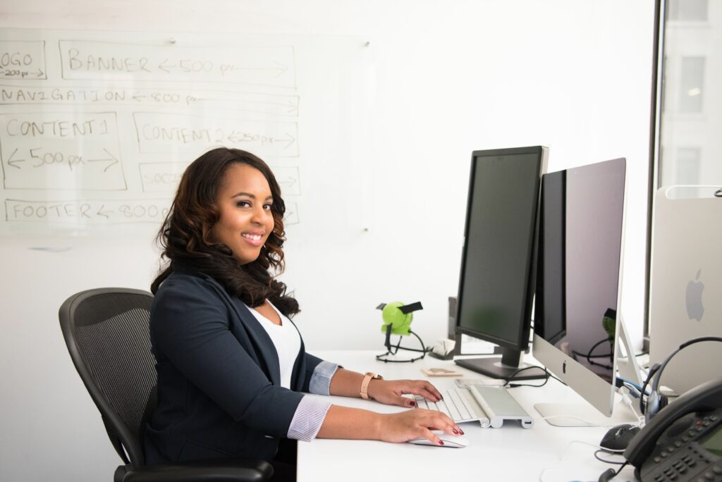 Office administrator working at a computer in a bright office